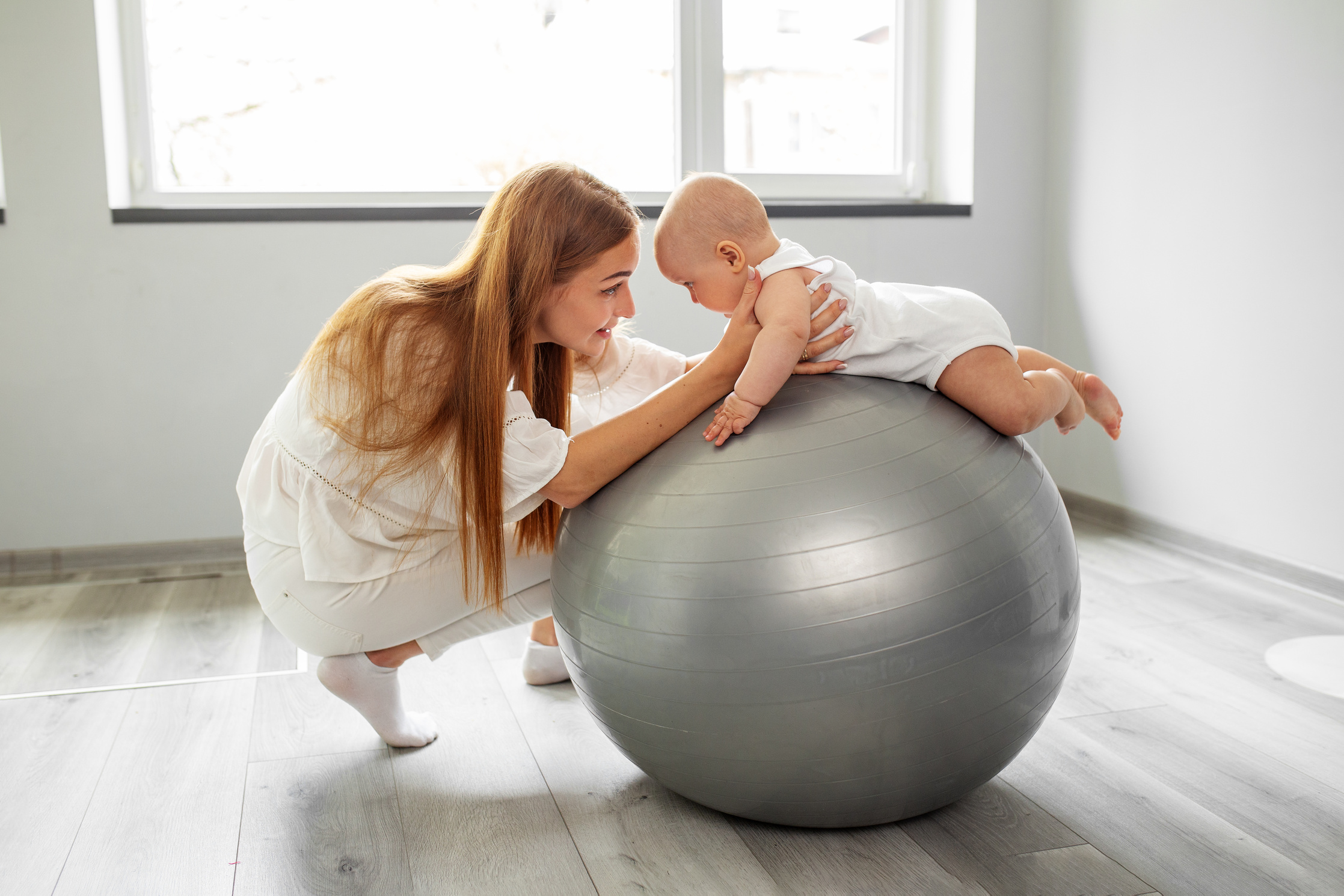 Stability ball exercises for neurodevelopment of baby. Low muscle ball. Tummy time.